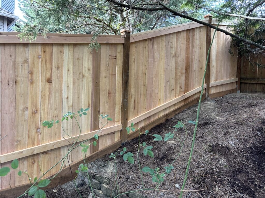 Completed cedar privacy fence following the grade on a Kirkland property